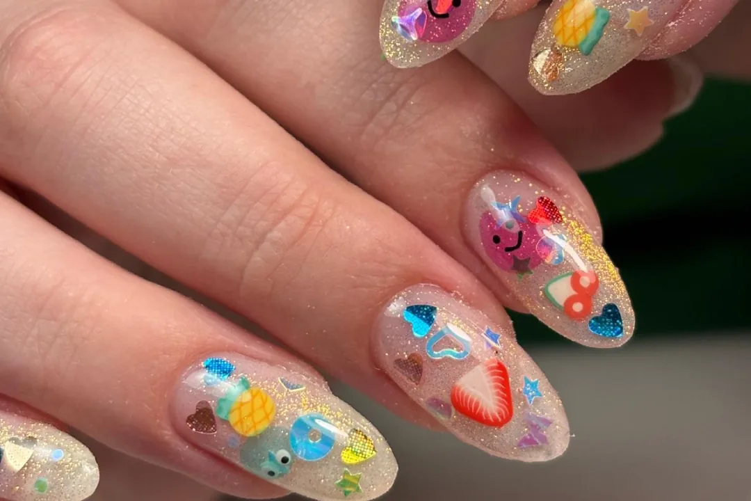 Clear glitter almond nails with fruit and heart charms